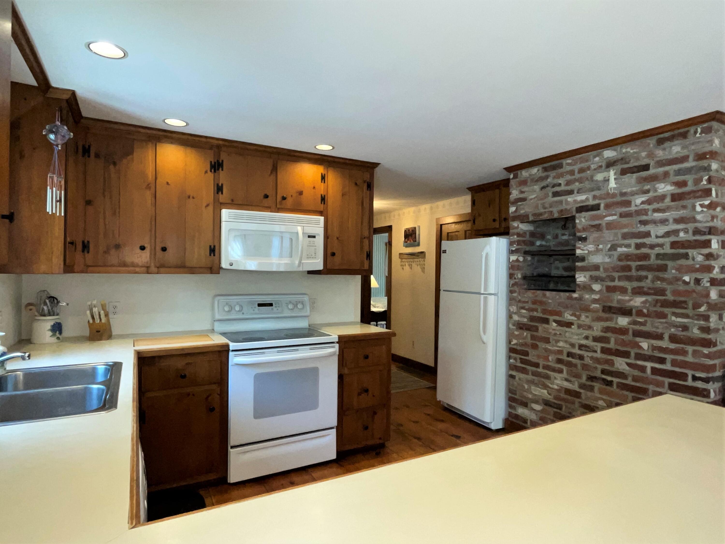 144 Long Road Harwich, MA 02645 - Photo 26 of 49 a kitchen with a stove a refrigerator and a sink