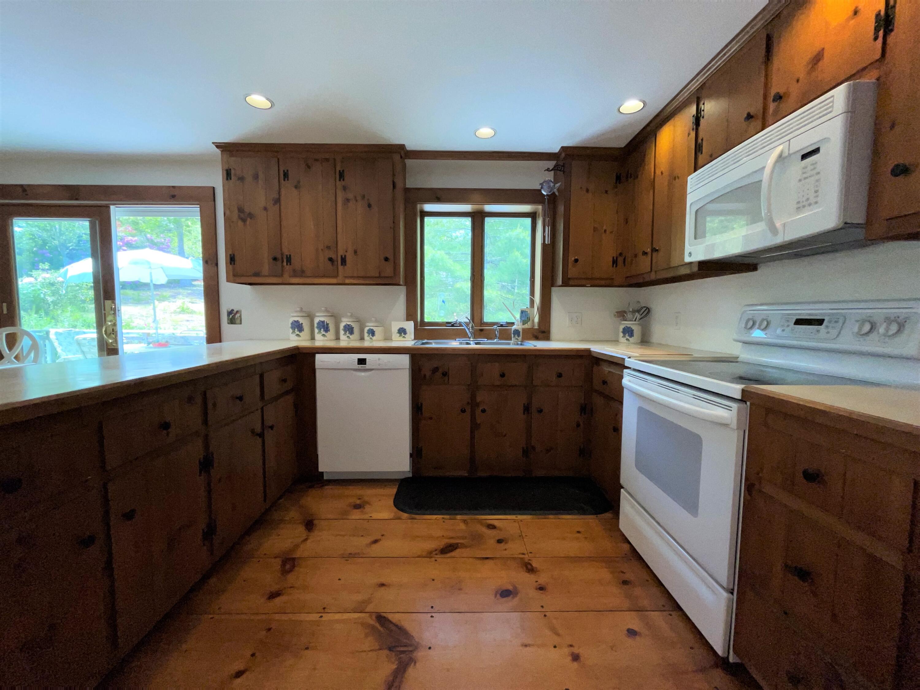 144 Long Road Harwich, MA 02645 - Photo 27 of 49 a kitchen with a sink stove and microwave