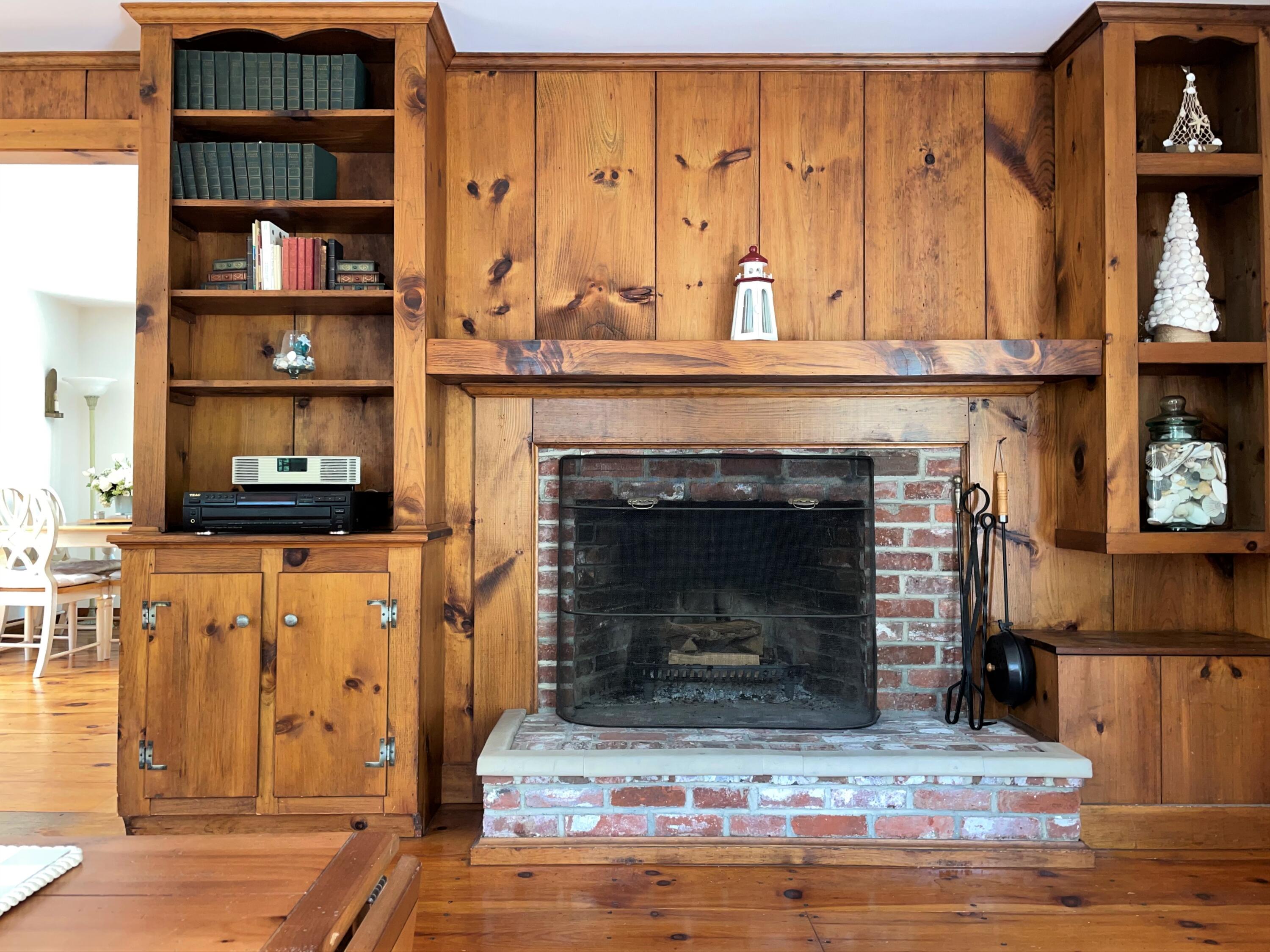 144 Long Road Harwich, MA 02645 - Photo 30 of 49 a living room with hard wood floors and a fireplace