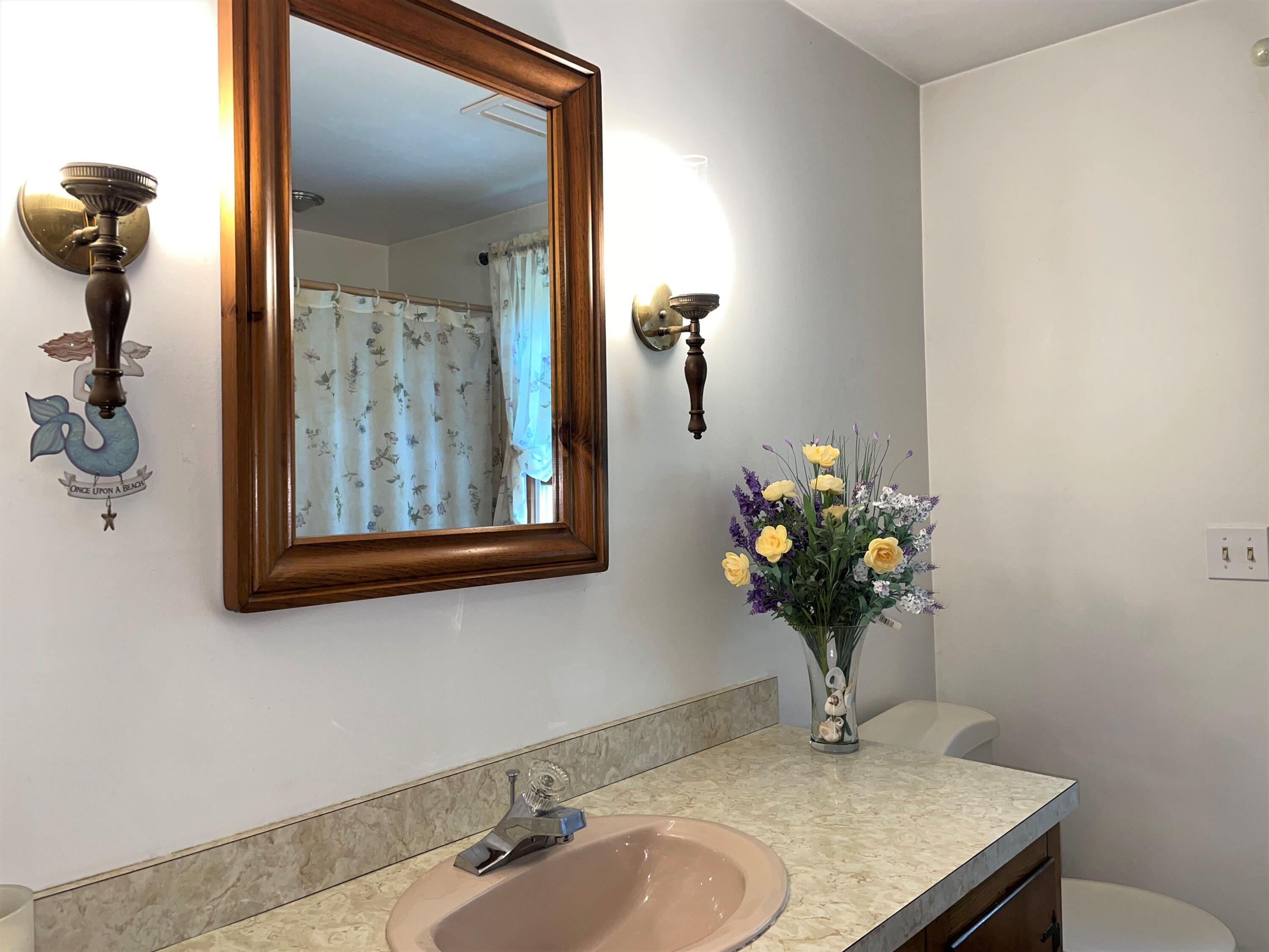 144 Long Road Harwich, MA 02645 - Photo 31 of 49 a bathroom with a sink mirror and vanity