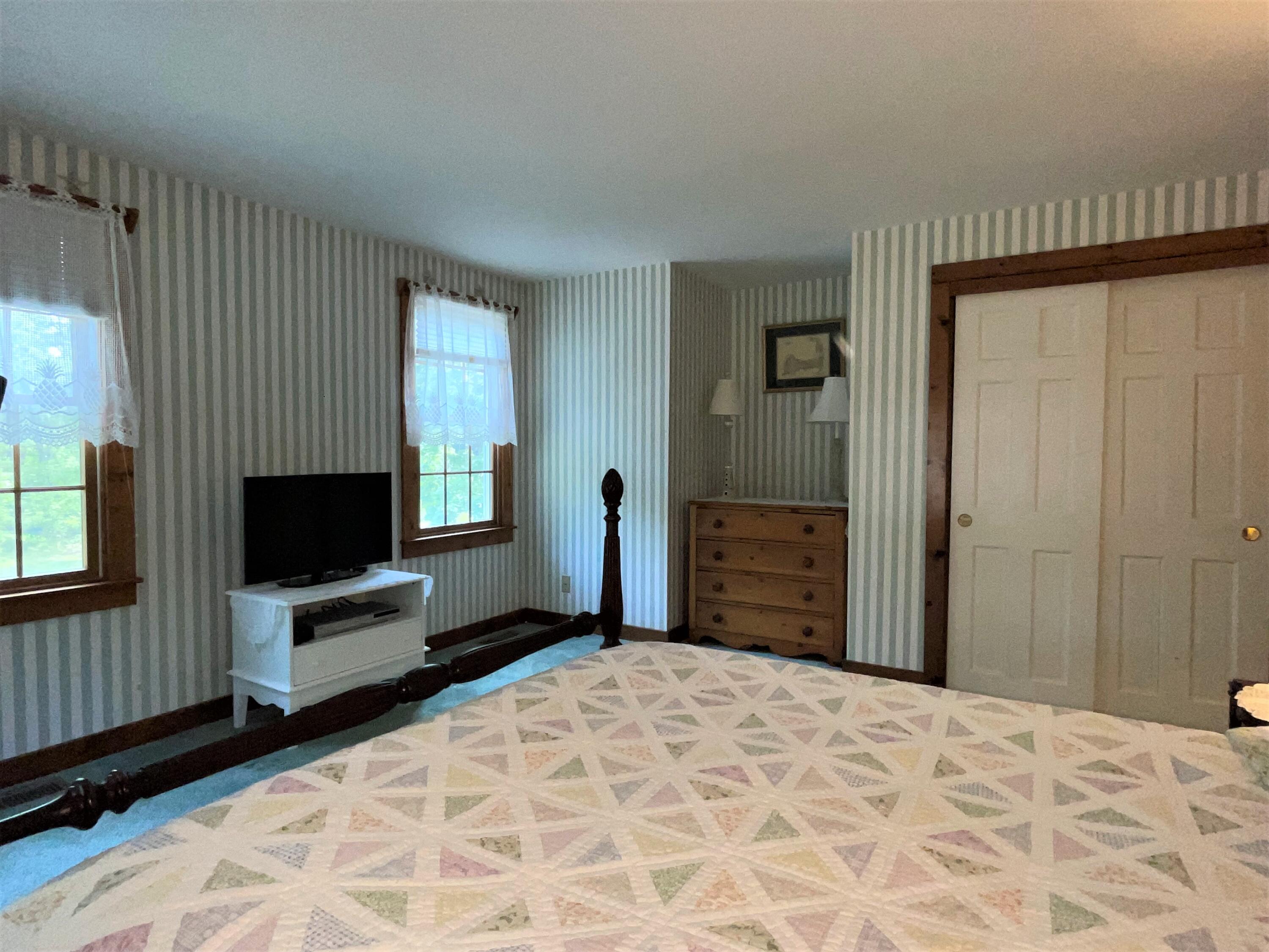 144 Long Road Harwich, MA 02645 - Photo 35 of 49 a bedroom with a bed and a flat screen tv