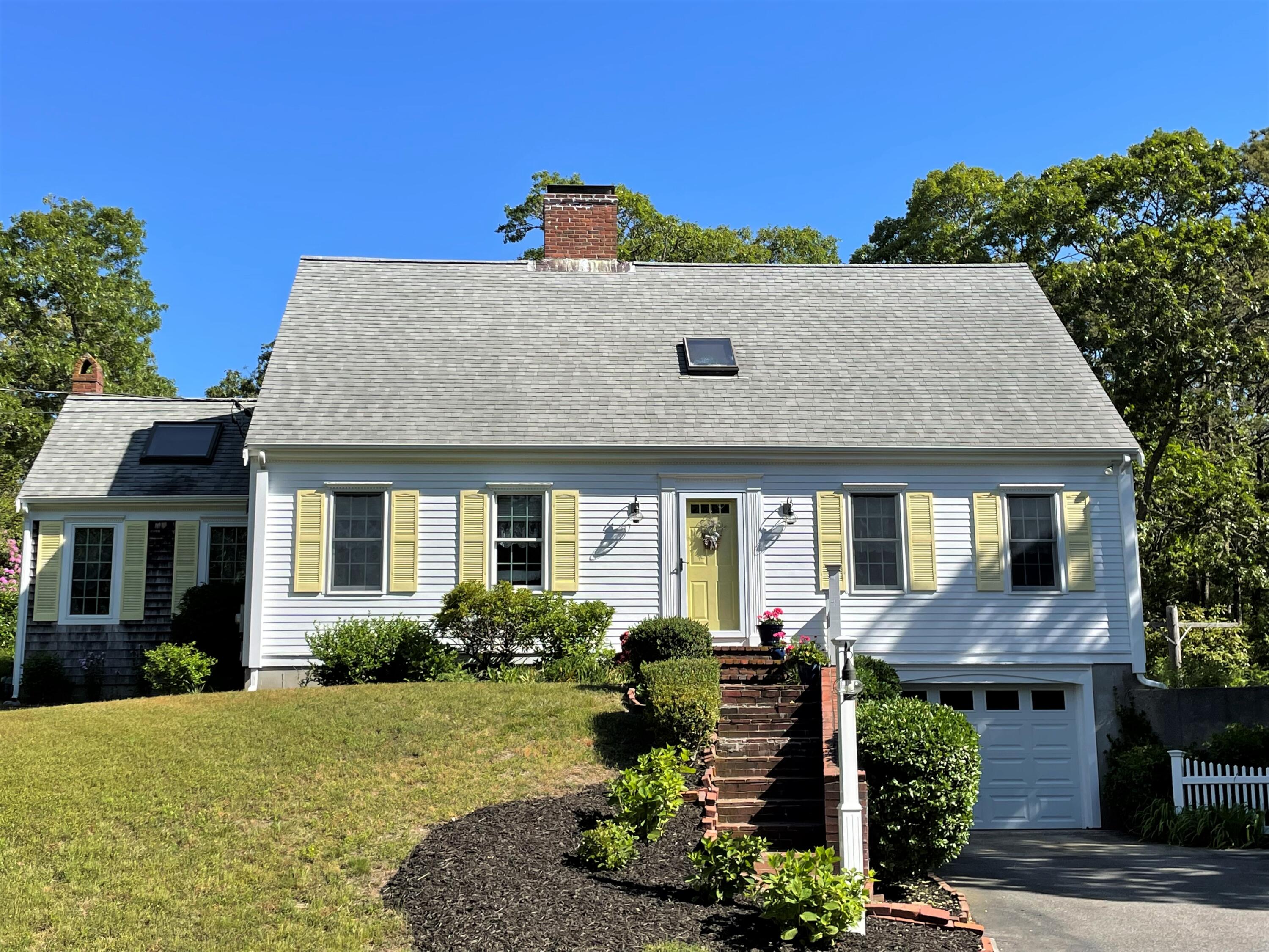 144 Long Road Harwich, MA 02645 - Photo 4 of 49 a front view of a house with a yard