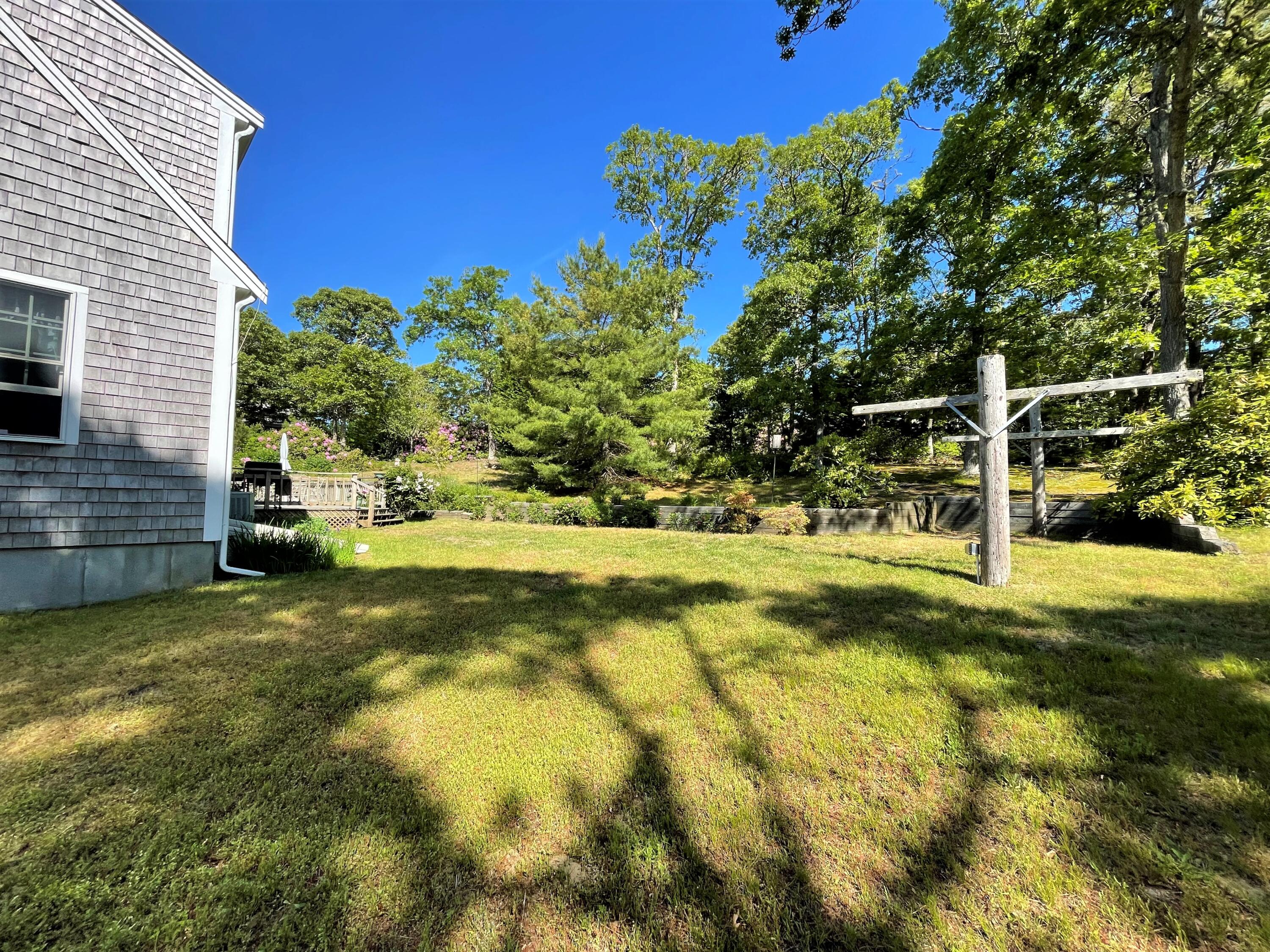 144 Long Road Harwich, MA 02645 - Photo 9 of 49 a view of swimming pool with lawn chairs and plants