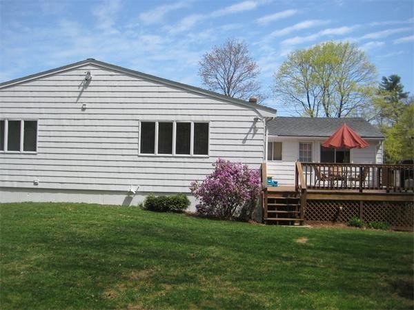 25 Lyndon Road Sharon, MA 02067 - Photo 19 of 27 a front view of a house with a yard and garage