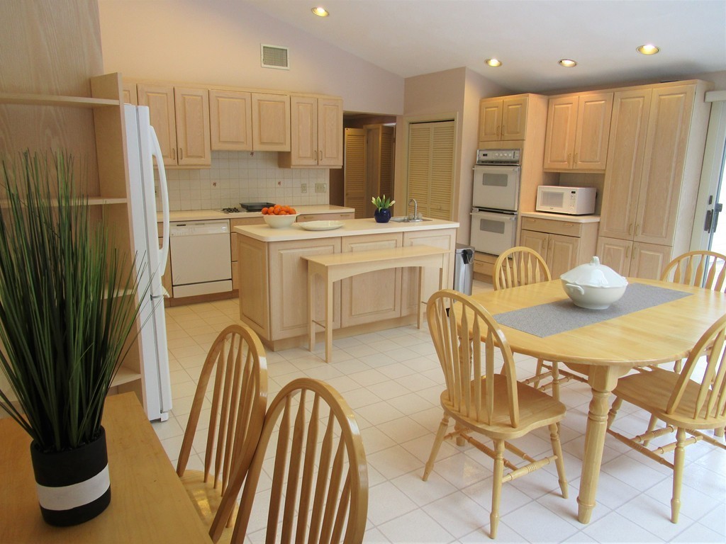 25 Lyndon Road Sharon, MA 02067 - Photo 4 of 27 a kitchen with refrigerator and chairs