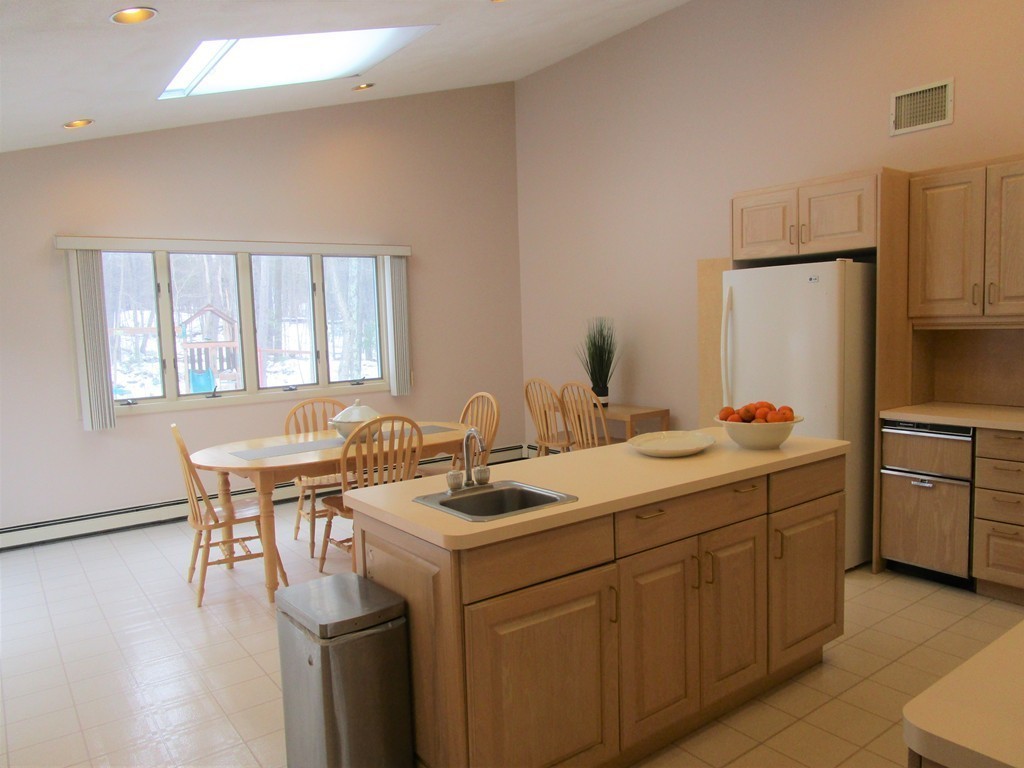 25 Lyndon Road Sharon, MA 02067 - Photo 5 of 27 a view of a kitchen counter space a sink wooden floor and a window