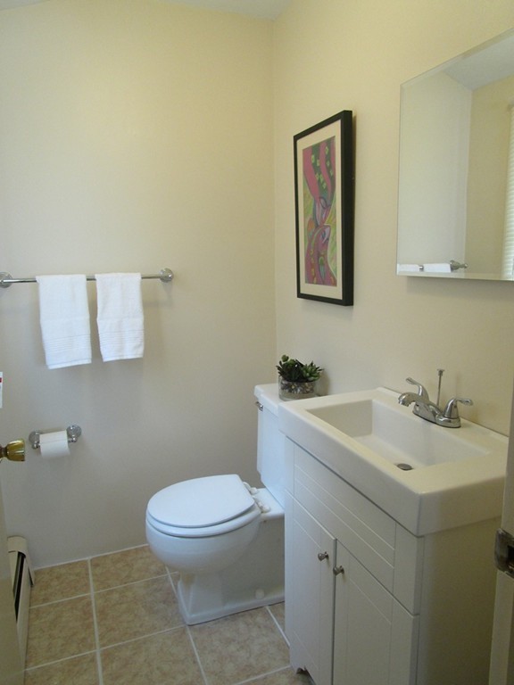 25 Lyndon Road Sharon, MA 02067 - Photo 9 of 27 a bathroom with a toilet sink vanity and mirror