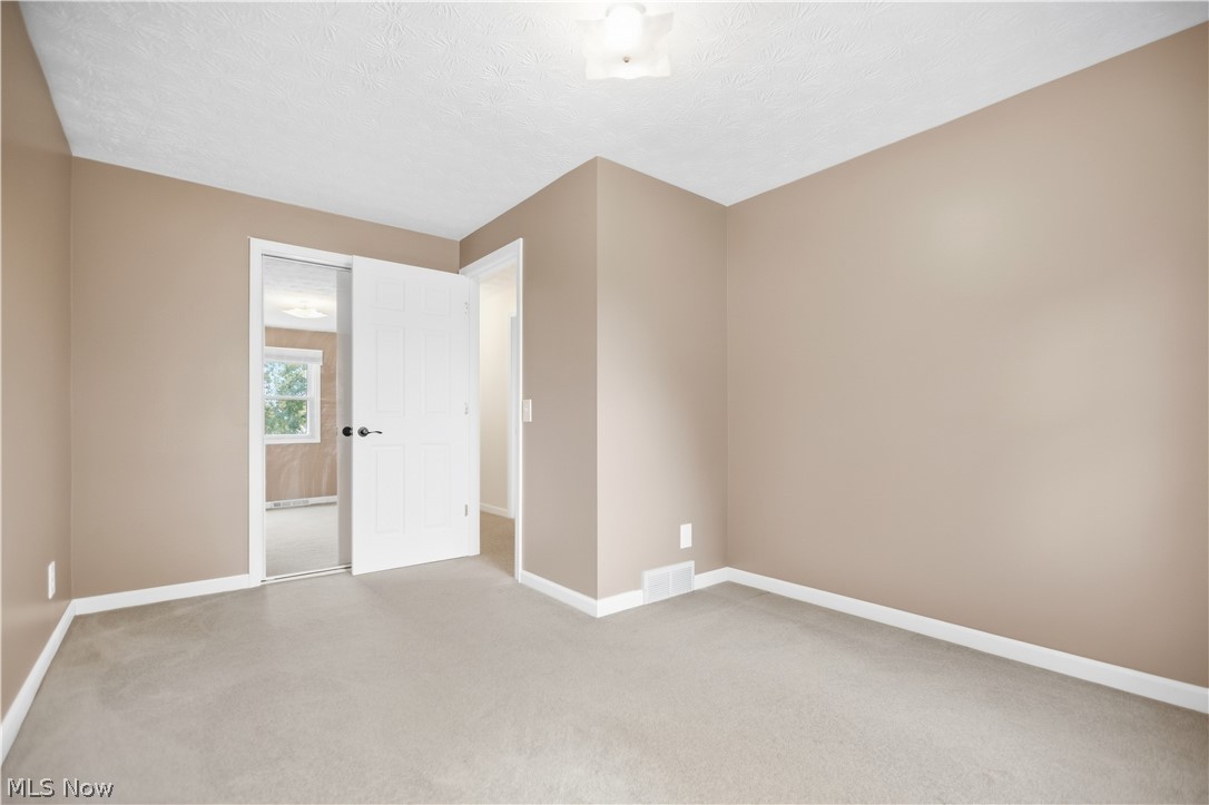 5972 Keller Road Akron, OH 44319 - Photo 19 of 29 Neutral-toned walls, light-colored carpeting, and a flush mount ceiling fixture