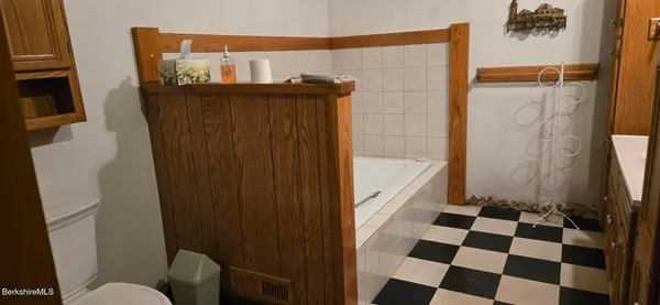 a bathroom with a black white checkered floor and a sink