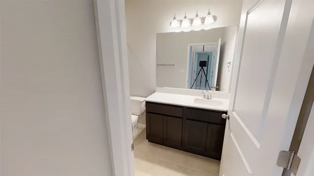 a white toilet sitting next to a bath tub