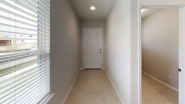 a view of a hallway with a window