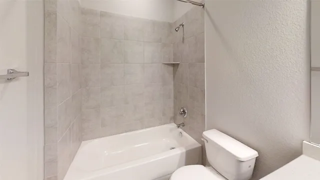 a bathroom with a toilet and a bathtub