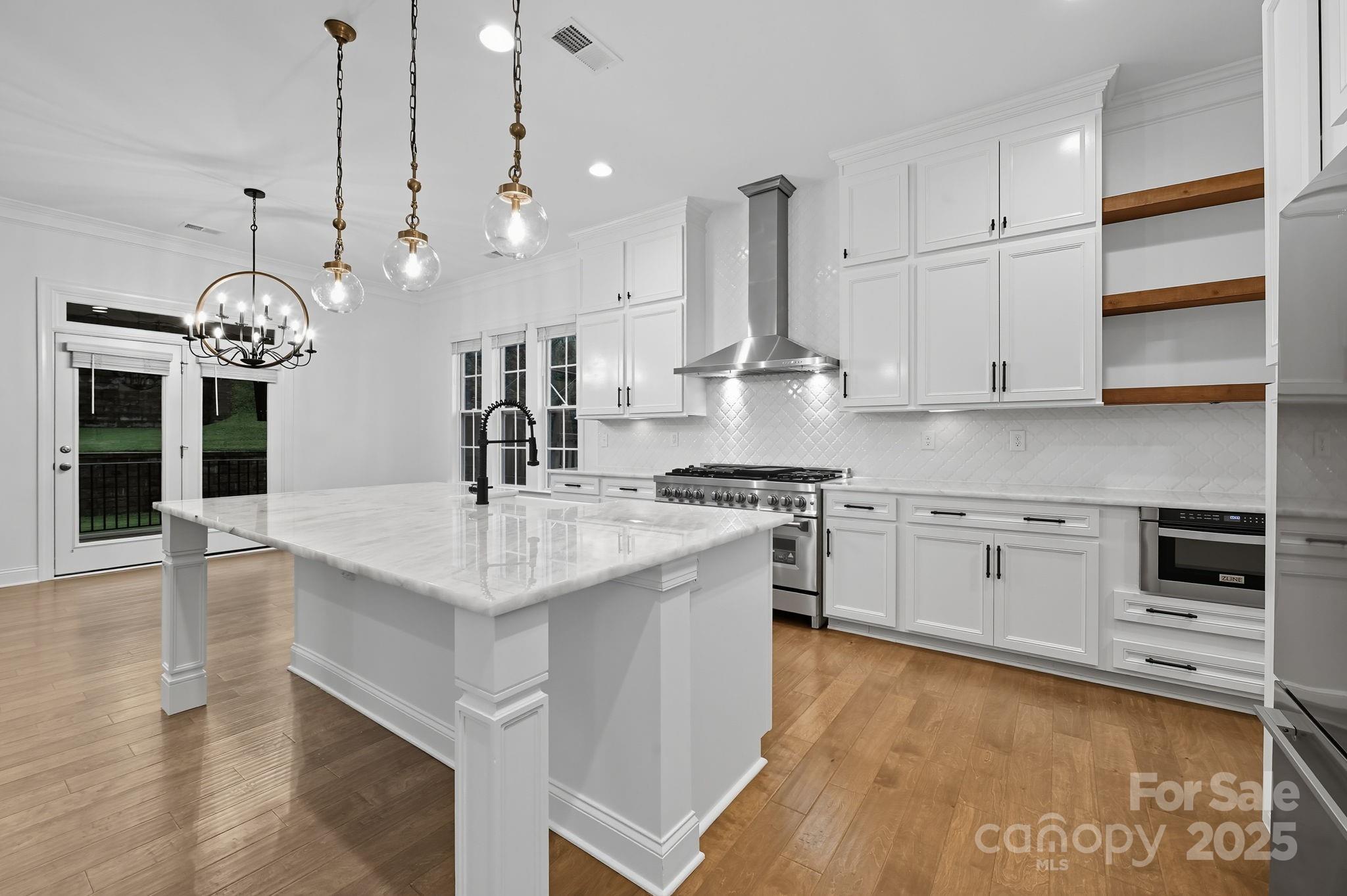 425 Cassia Court Tega Cay, SC 29708 - Photo 11 of 39 a kitchen with stainless steel appliances granite countertop a sink a stove and a refrigerator