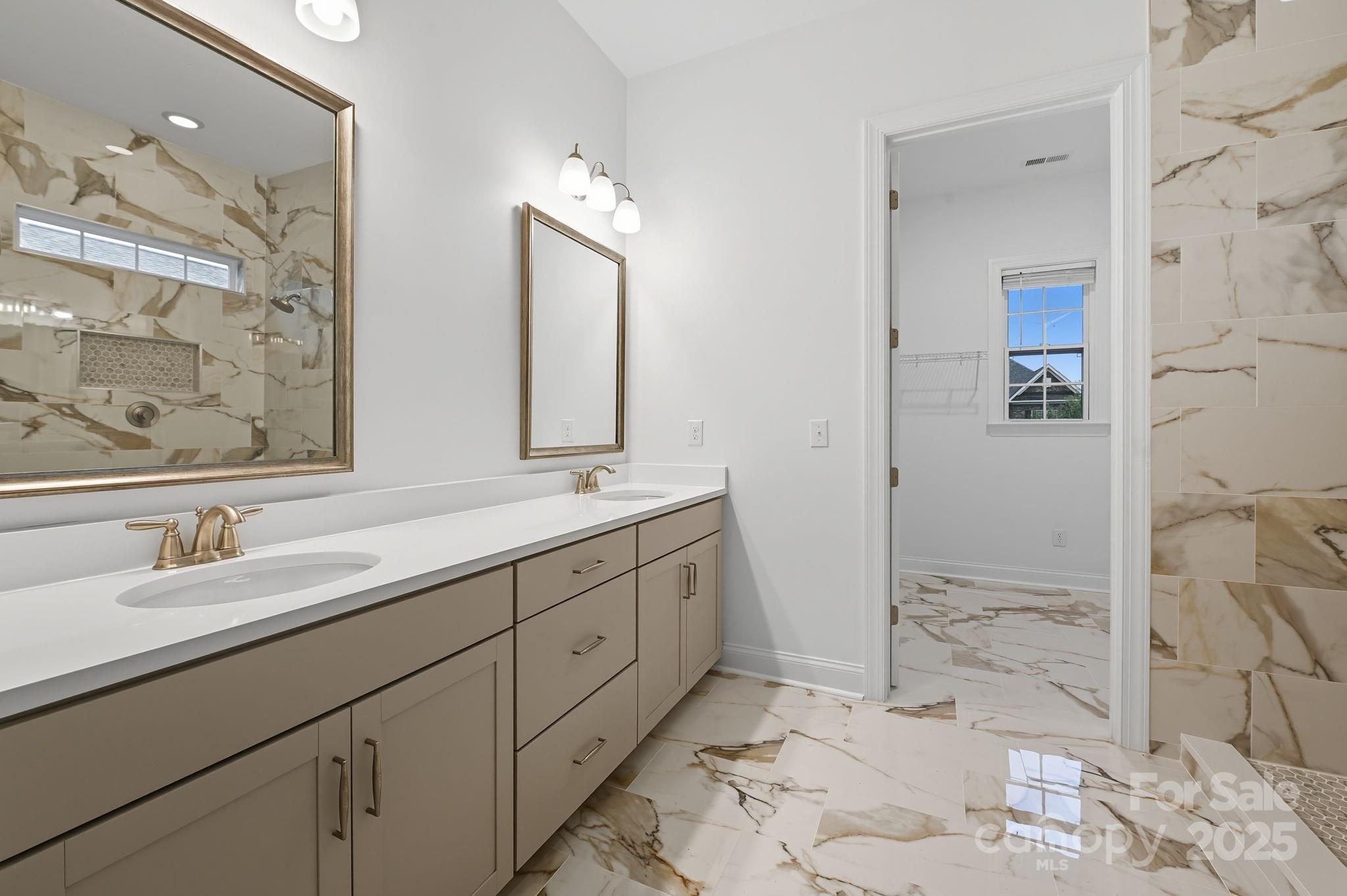 425 Cassia Court Tega Cay, SC 29708 - Photo 15 of 39 a bathroom with a double vanity sink mirror and shower