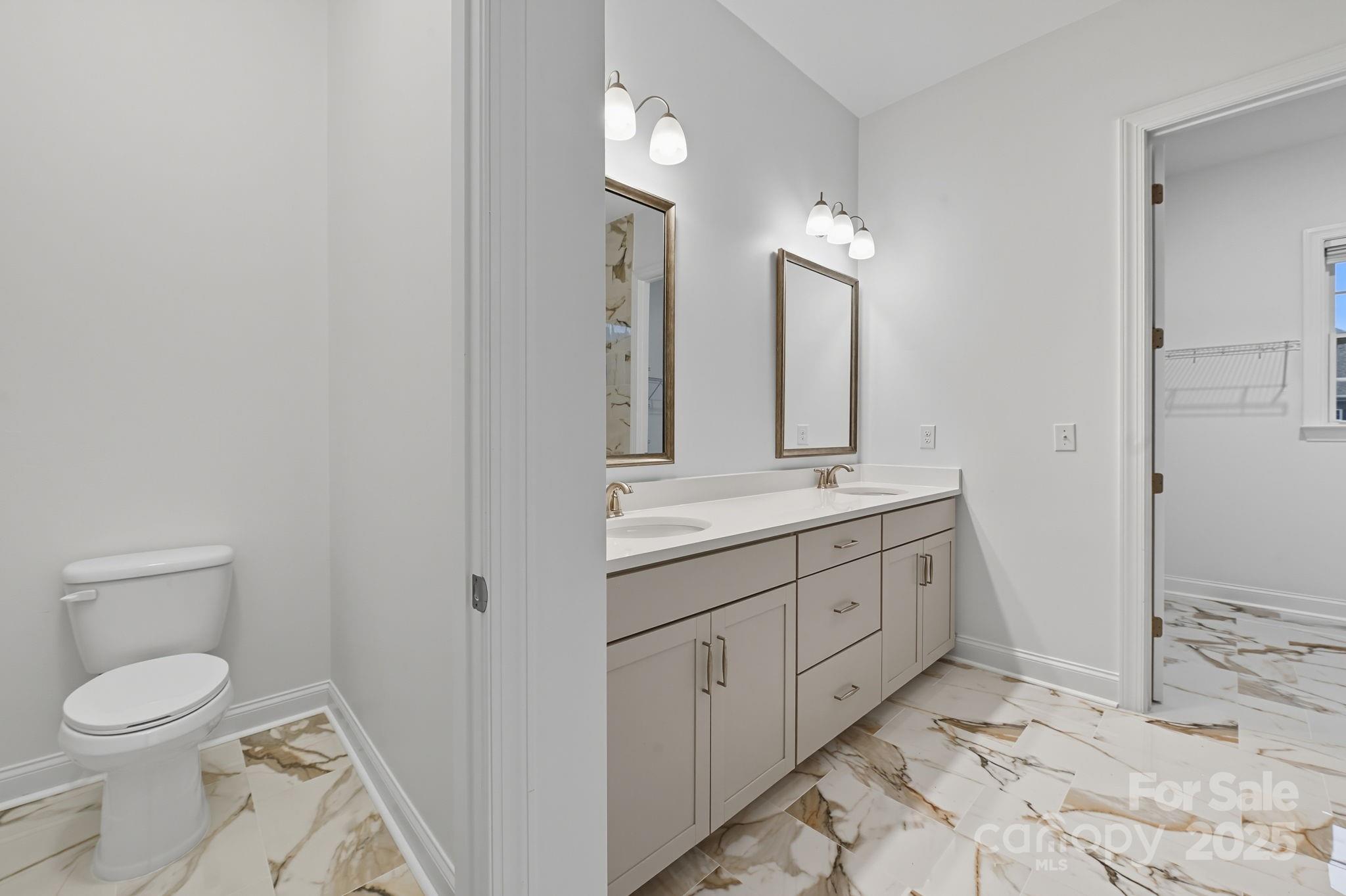 425 Cassia Court Tega Cay, SC 29708 - Photo 17 of 39 a bathroom with a toilet sink and mirror
