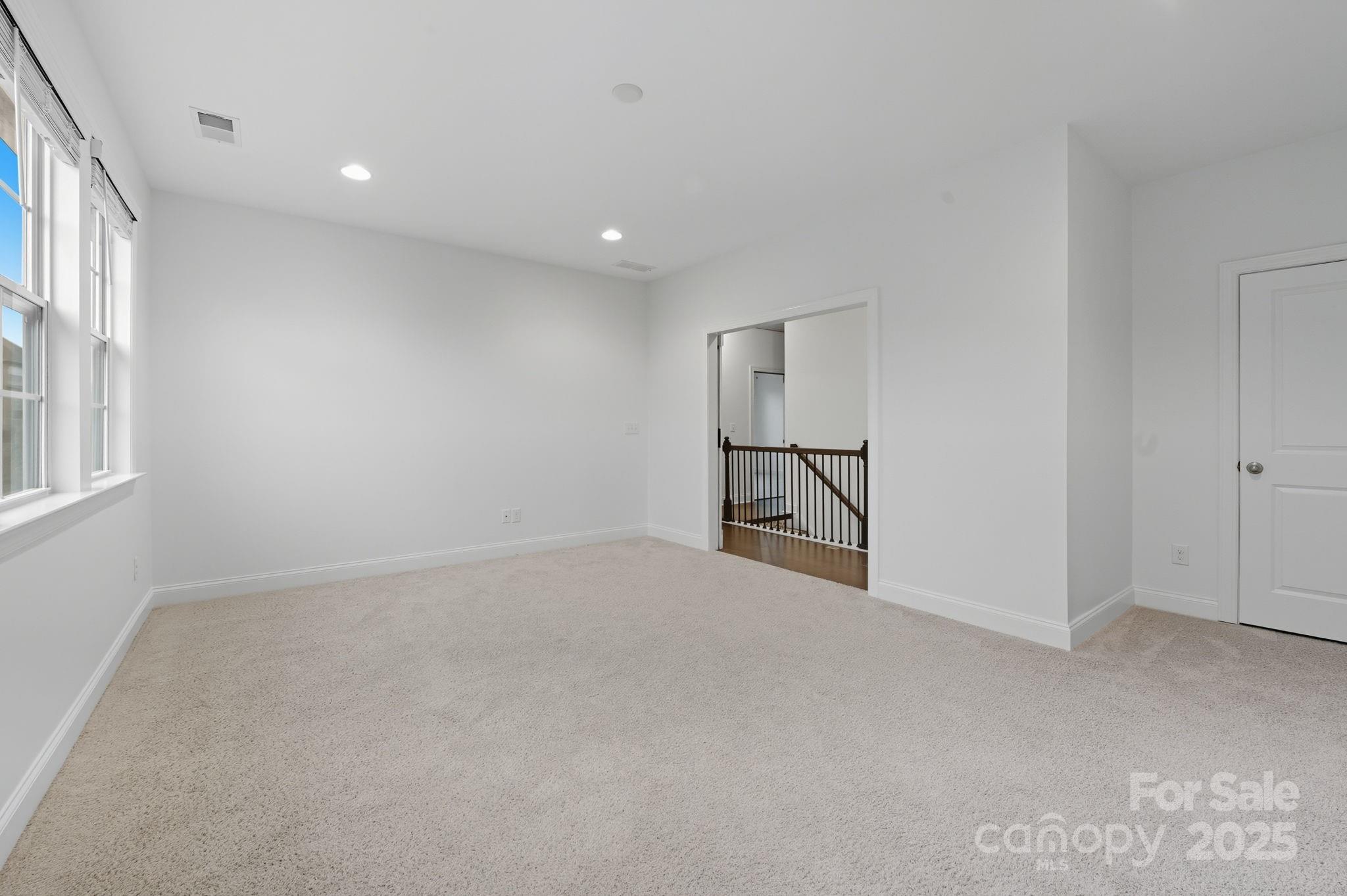 425 Cassia Court Tega Cay, SC 29708 - Photo 18 of 39 an empty room with windows and pillars in it