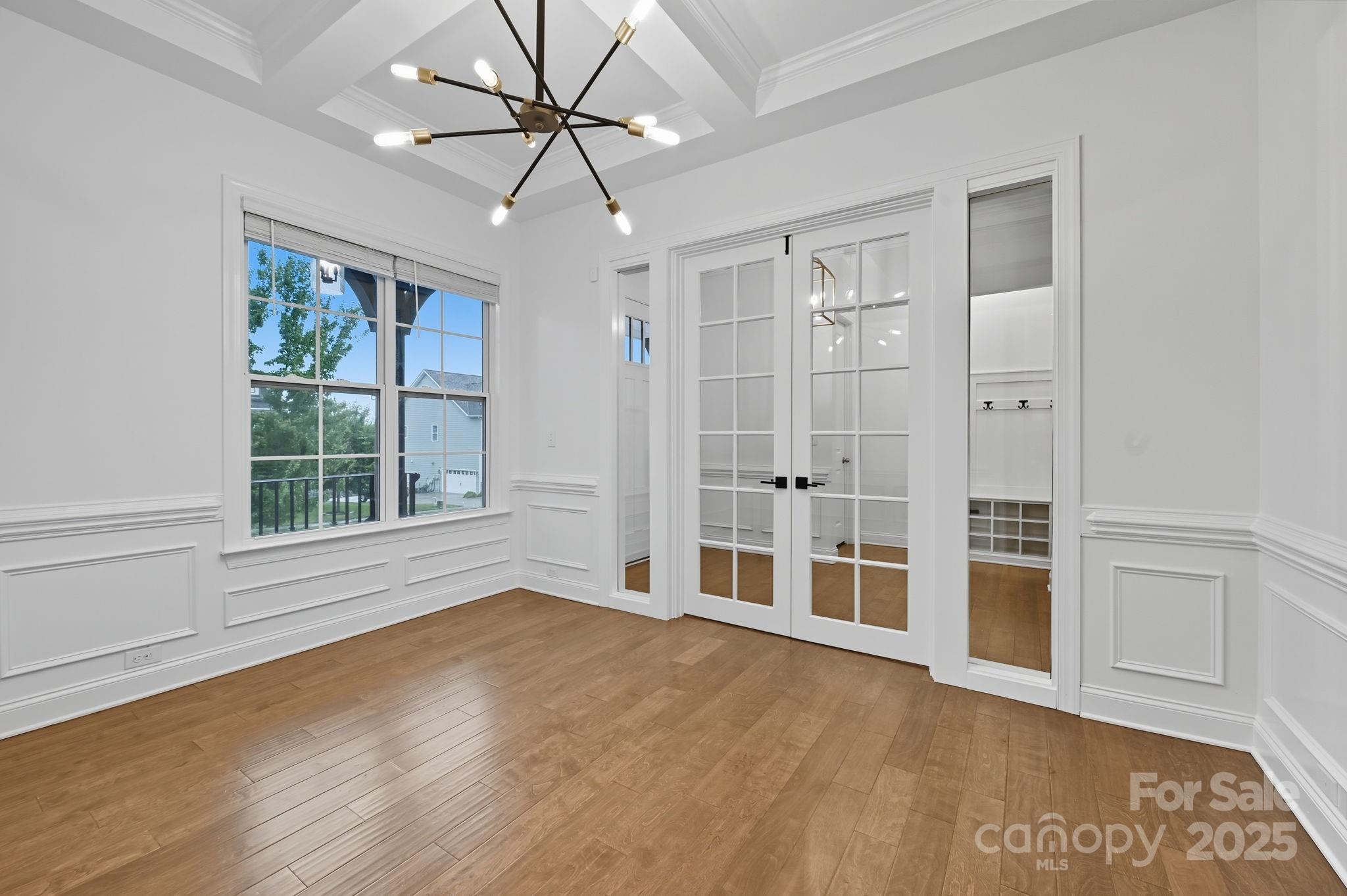425 Cassia Court Tega Cay, SC 29708 - Photo 30 of 39 a view of an empty room with a window and wooden floor