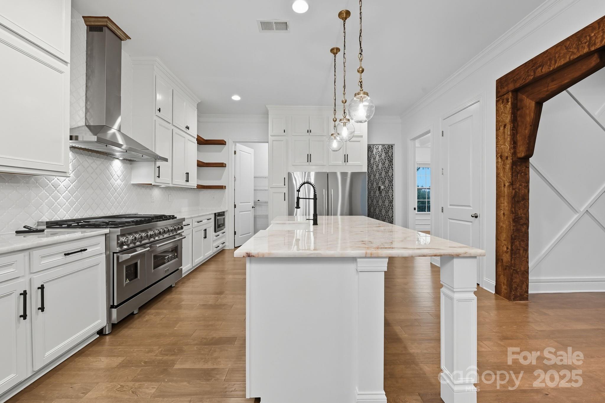 425 Cassia Court Tega Cay, SC 29708 - Photo 10 of 39 a kitchen with kitchen island a stove a sink a refrigerator and a refrigerator