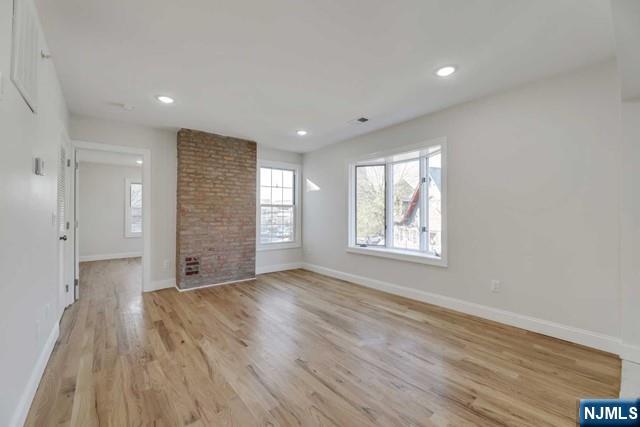 401 Franklin Street, Unit 2 Bloomfield, NJ 07003 - Photo 7 of 13 a view of an empty room with a window and wooden floor