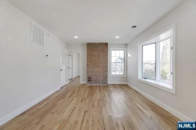 a view of a kitchen with a refrigerator and a window