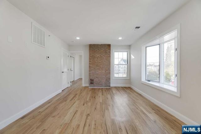 401 Franklin Street, Unit 2 Bloomfield, NJ 07003 - Photo 8 of 13 a view of an empty room with wooden floor and a window
