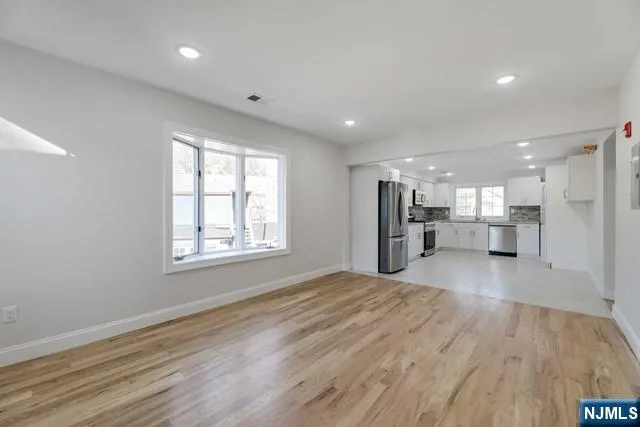 a view of an empty room and a window