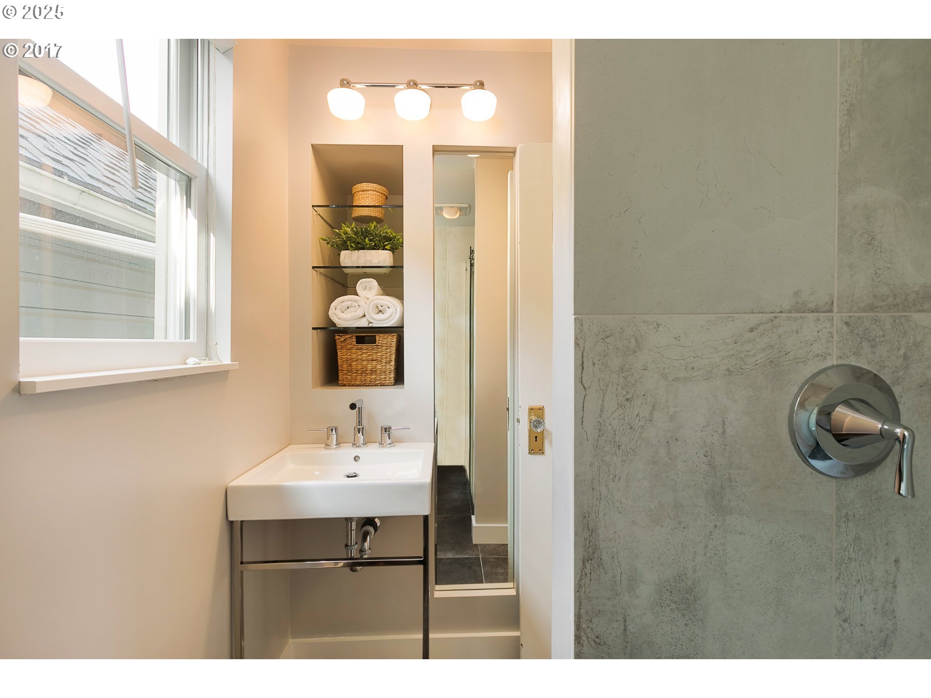 2137 Northwest Everett Street, Unit B Portland, OR 97210 - Photo 12 of 28 a bathroom with a sink a light fixture and a mirror