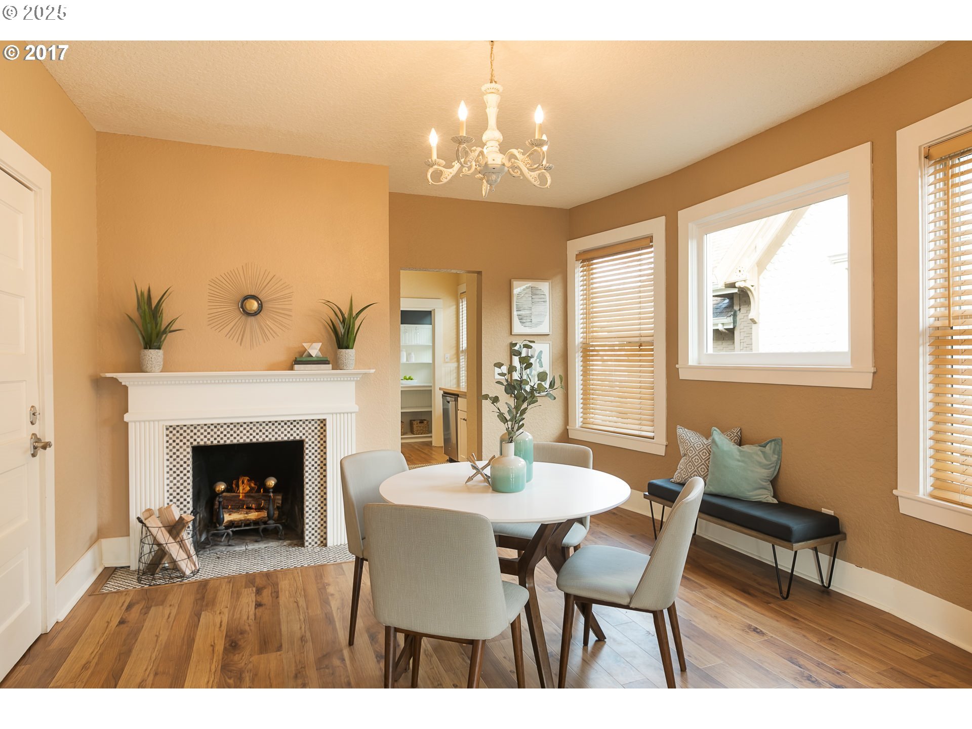 2137 Northwest Everett Street, Unit B Portland, OR 97210 - Photo 6 of 28 a dining room with furniture a fireplace and a chandelier