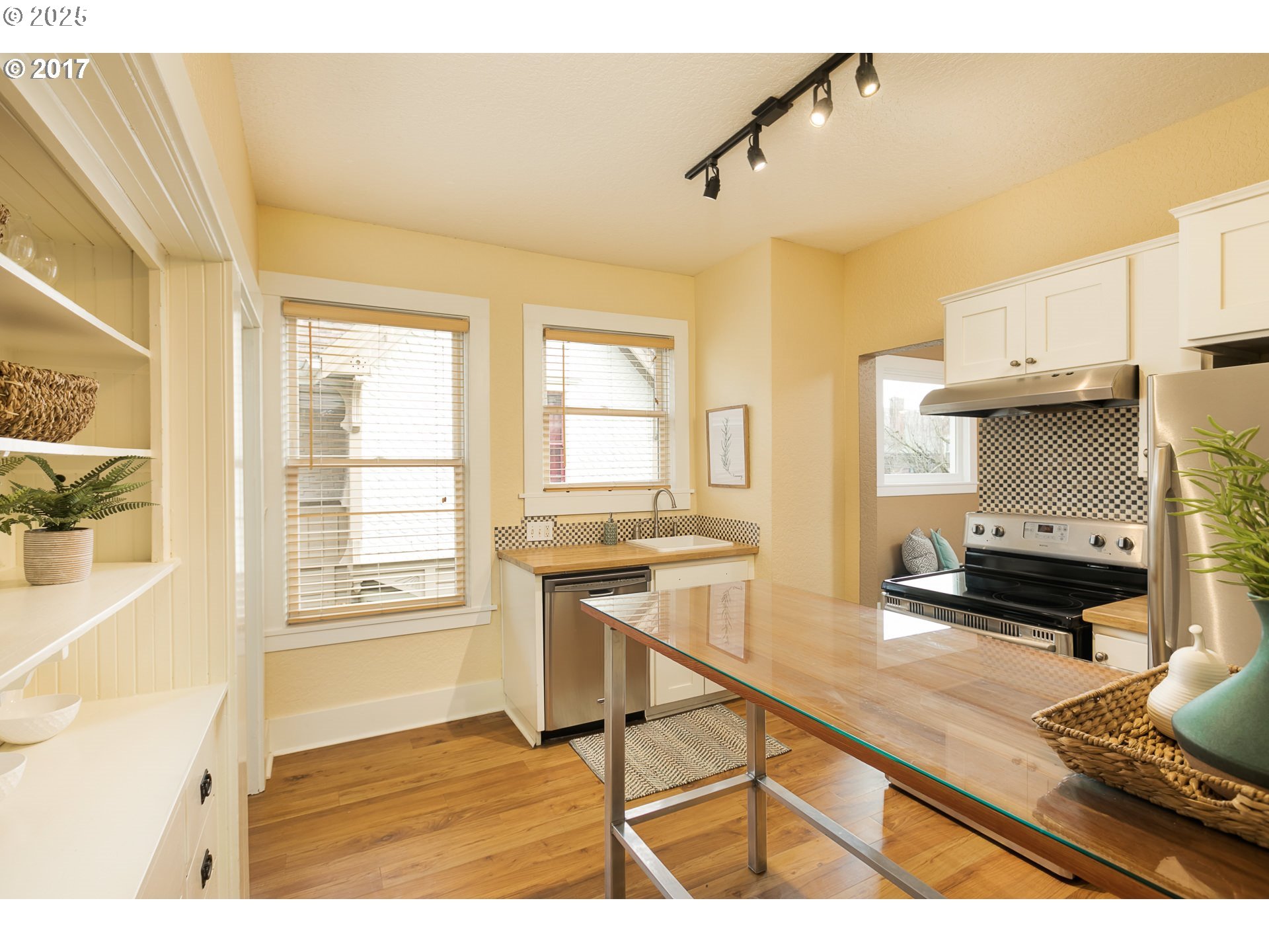 2137 Northwest Everett Street, Unit B Portland, OR 97210 - Photo 8 of 28 a kitchen with stainless steel appliances granite countertop a sink stove and wooden cabinets