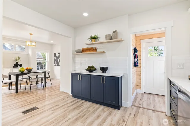 a kitchen with stainless steel appliances granite countertop a sink and wooden floor