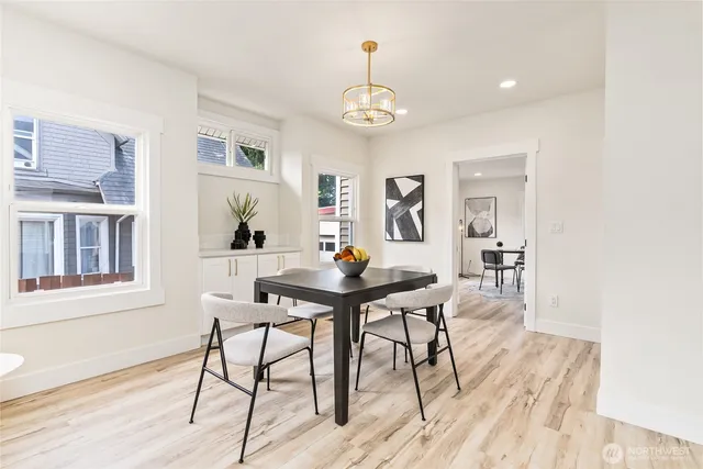 a view of a dining room with furniture and wooden floor