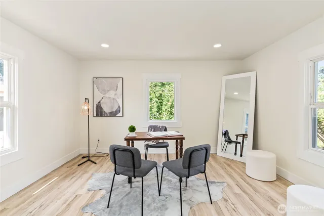 a dining room with furniture and wooden floor