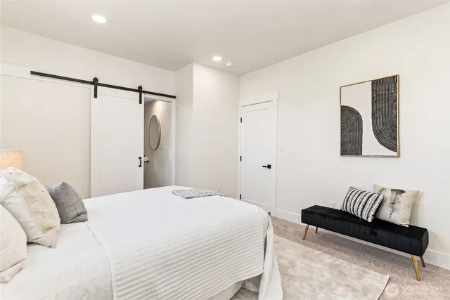 a bedroom with a bed and a couch