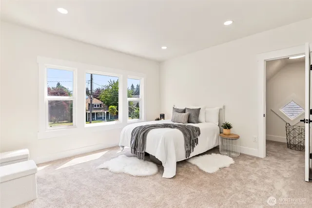 a spacious bedroom with a bed and a window