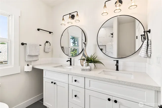 a bathroom with a granite countertop sink mirror and vanity