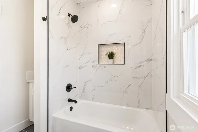 a bathroom with a bathtub and shower