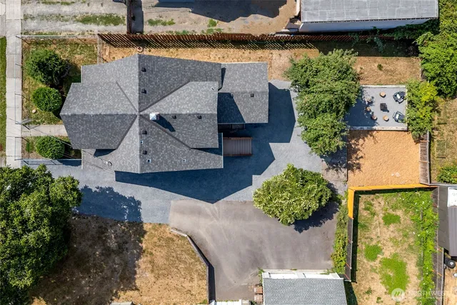 an aerial view of a house with a yard basket ball court and outdoor seating