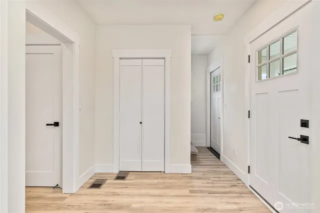 a view of a bathroom with wooden floor and closet