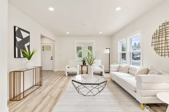 a living room with furniture and wooden floor