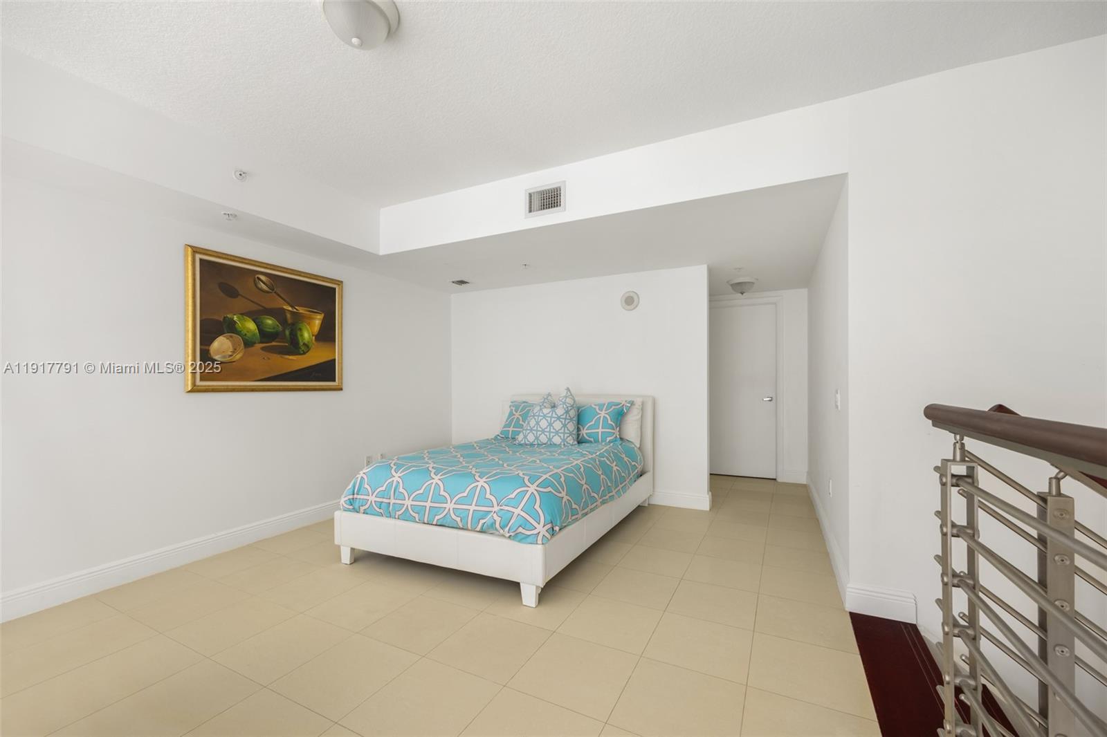 41 Southeast 5th Street, Unit 1210 Miami, FL 33131 - Photo 11 of 15 a bedroom with a bed and a painting on the wall