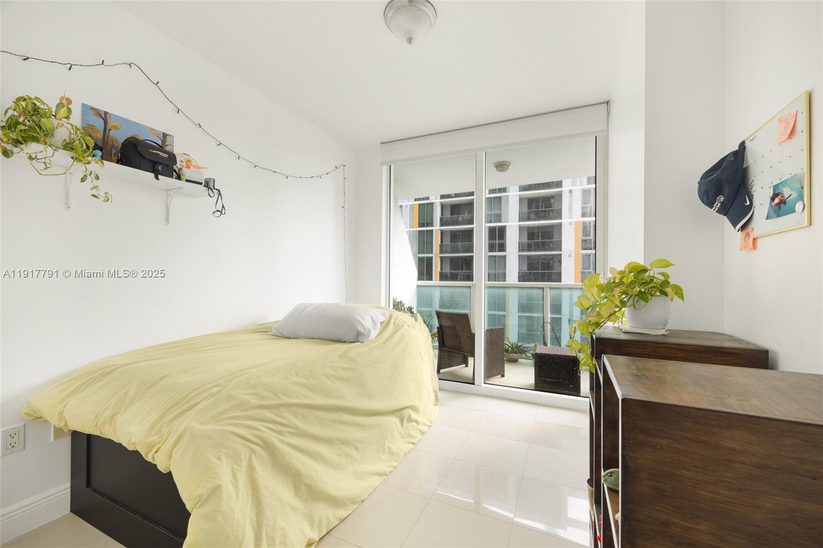 41 Southeast 5th Street, Unit 1210 Miami, FL 33131 - Photo 13 of 15 a bed sitting in a spacious bedroom next to a window