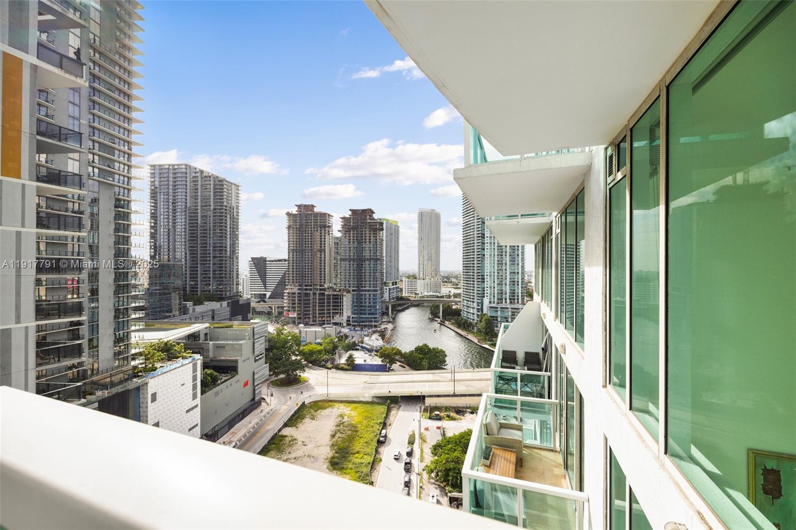 41 Southeast 5th Street, Unit 1210 Miami, FL 33131 - Photo 2 of 15 a view of a swimming pool with outdoor seating