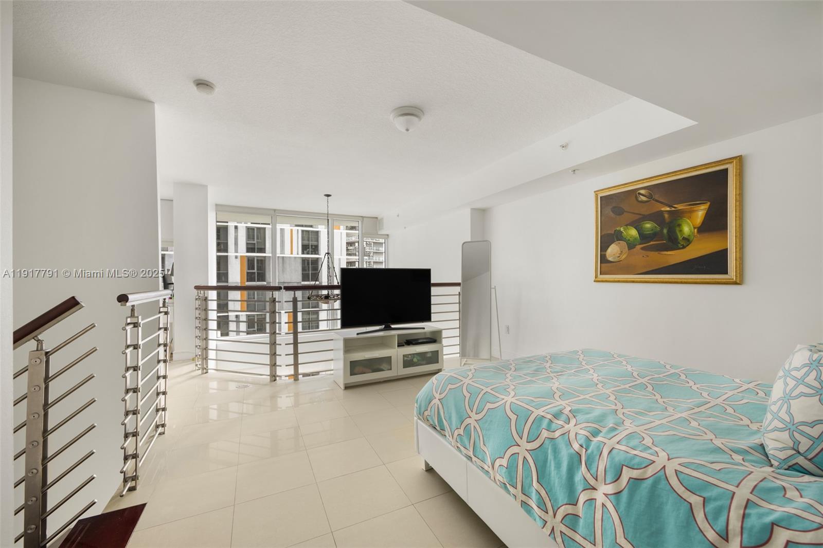 41 Southeast 5th Street, Unit 1210 Miami, FL 33131 - Photo 10 of 15 a bedroom with a bed and a flat screen tv
