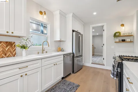 a kitchen with a sink stainless steel appliances and cabinets