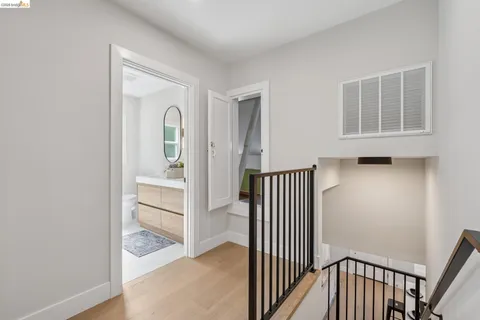 a view of a hallway with wooden floor and entryway