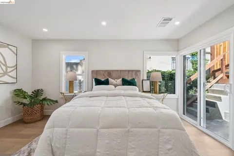 a bedroom with a large bed and a potted plant