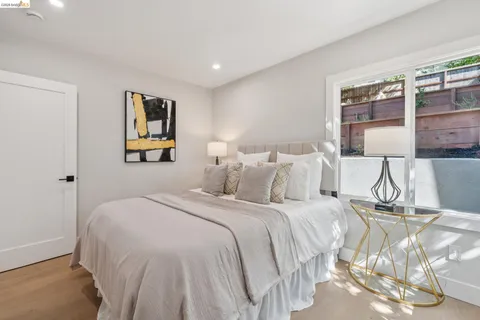 a bedroom with a bed and painting on the wall