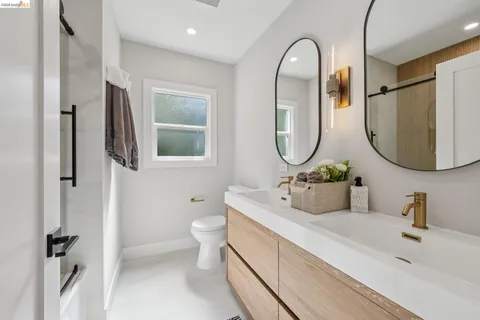a bathroom with a toilet a sink and a mirror