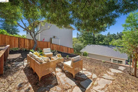 a backyard of a house with table and chairs