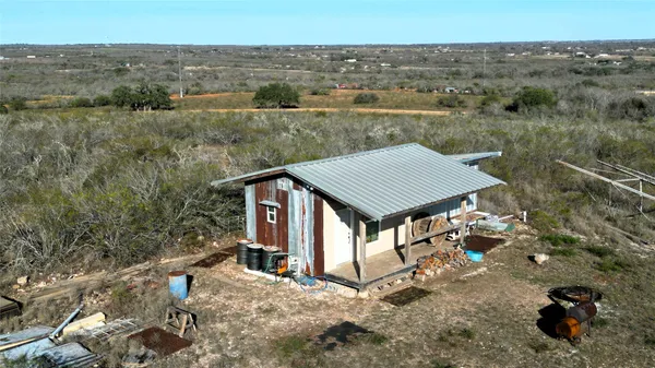 an aerial view of a house with a yard